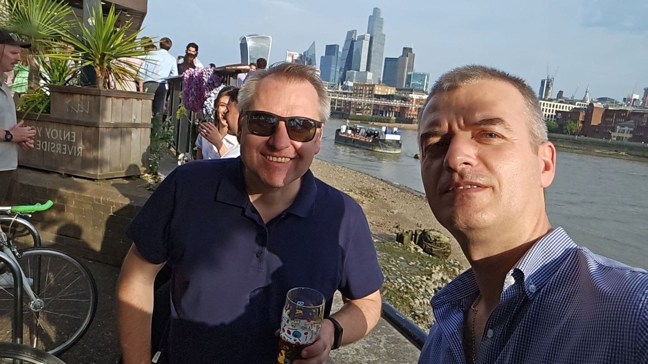 Two good friends enjoying a beer by the river